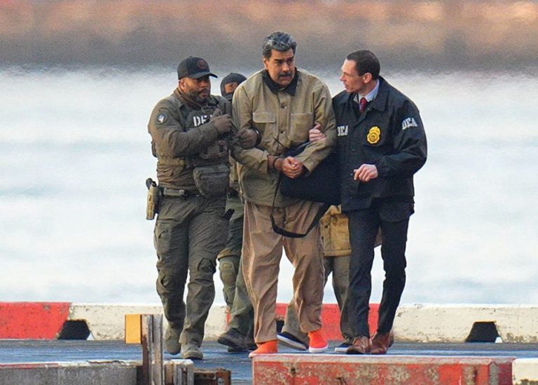 Nicolas Maduro is seen in handcuffs.