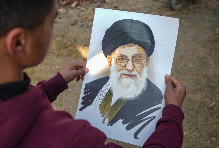 A boy holds a portrait of Iran's Supreme Leader Ayatollah Ali Khamenei in Srinagar, Jammu and Kashmir, on January 08, 2026. Iran's Supreme Leader Ayatollah Ali Khamenei vows not to yield after U.S. President Donald Trump threatens to come to the aid of protesters, as rights groups report a sharp rise in arrests following days of unrest sparked by soaring inflation. Meanwhile, Iran's top judge warns protesters on Wednesday there is ''no leniency for those who help the enemy against the Islamic Republic,'' while accusing Israel and the U.S. of pursuing hybrid methods to disrupt the country. (Photo by Firdous Nazir/NurPhoto via Getty Images)