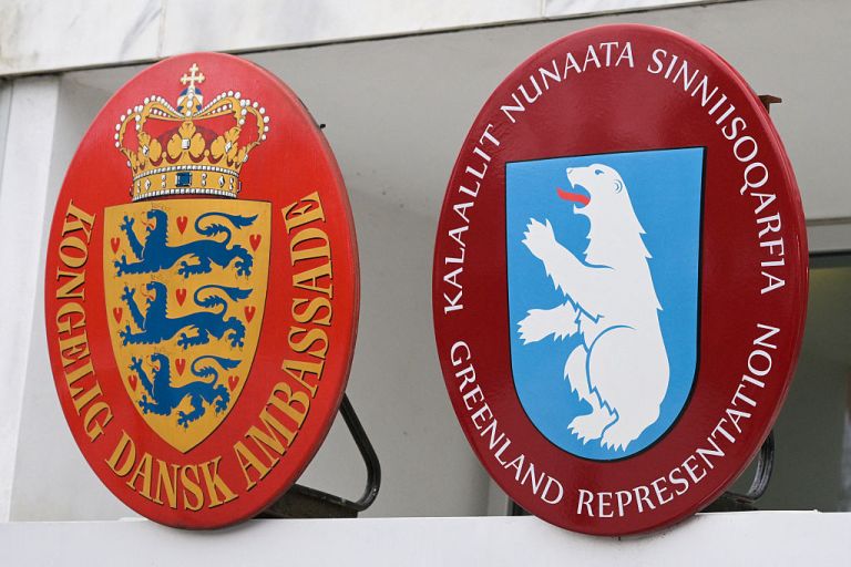 The Danish coat of arms and Greenland's coat of arms are seen at the Danish Embassy in Washington, DC, ahead of a news conference with Danish Foreign Minister Lars Lokke Rasmussen and Greenland's Foreign Minister Vivian Motzfeldt on January 14, 2026. Denmark and Greenland's top diplomats held high-stakes talks at the White House on Wednesday, with President Donald Trump warning it was 