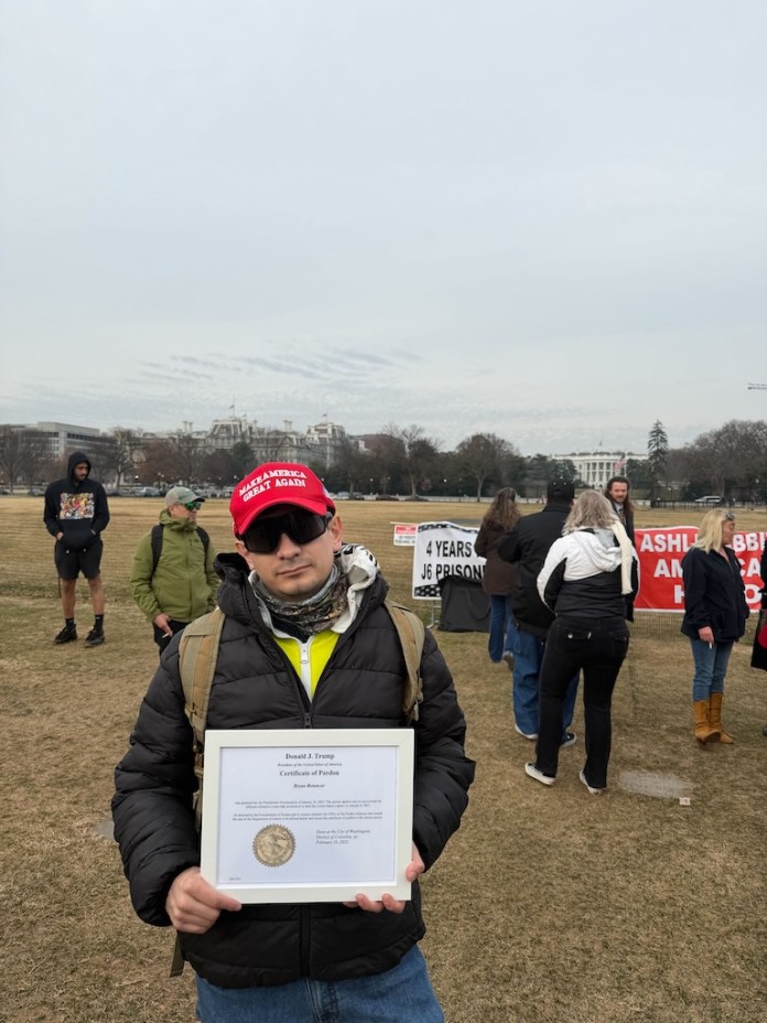 Bryan Betancur holds up his pardon from President Donald Trump at the Ellipse in Washington, D.C., on Jan. 6, 2026. (Sydney Topf/Washington Examiner)