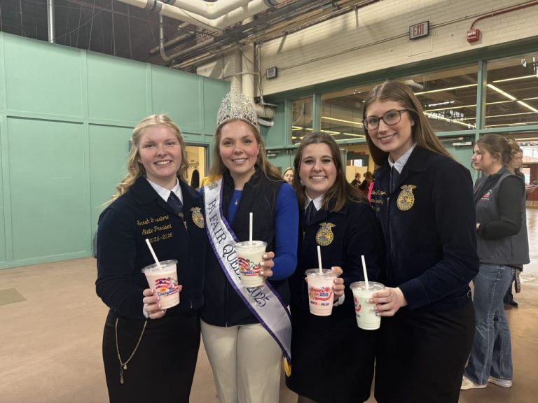Members of the Future Farmers of America, holding their dairyman milkshakes.