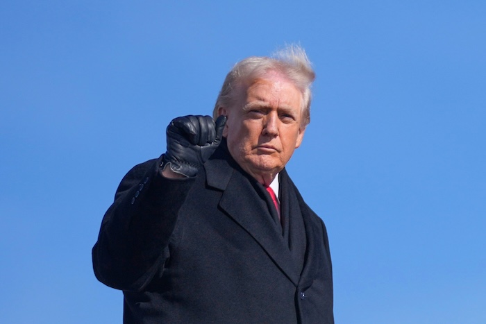 President Donald Trump raises a fist.