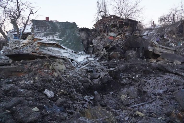 An air bomb crater in the foreground of destroyed private houses following a Russian airstrike in Kharkiv, Ukraine.