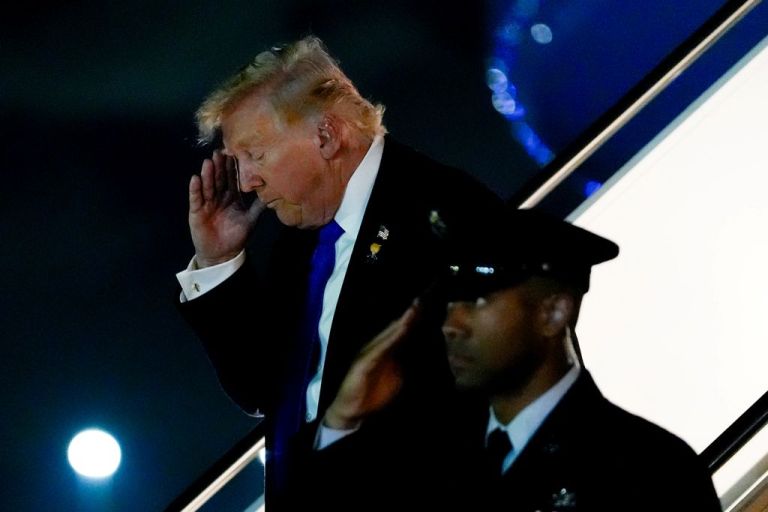 Trump deplanes from Air Force One.