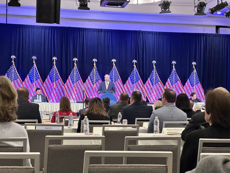 RNC Chairman Joe Gruters speaks at the RNC winter meeting with a line of American flags behind him in Santa Barbara, California, on Jan. 23, 2026. (Barnini Chakraborty/Washington Examiner)