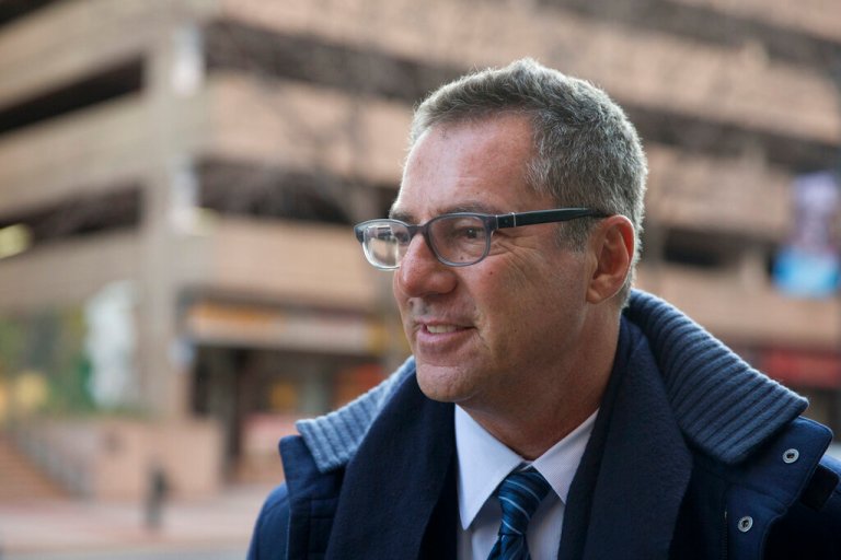 In this Nov. 19, 2014, file photo, NFL lawyer Brad Karp leaves federal court after a hearing on the proposed NFL concussion settlement, in Philadelphia. Lawyers for the NFL and retired players filed proposed changes to the $1 billion concussion settlement on Wednesday, Oct. 20, 2021, to remove race-norming in dementia testing, which made it more difficult for Black players to qualify for payments.