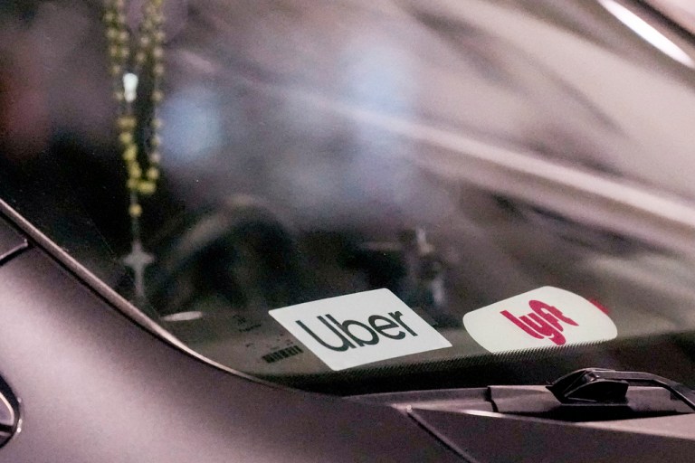 Uber and Lyft stickers are seen on a ride share vehicle is seen at the Nashville International Airport, Friday, Aug. 30, 2024, in Nashville, Tenn.