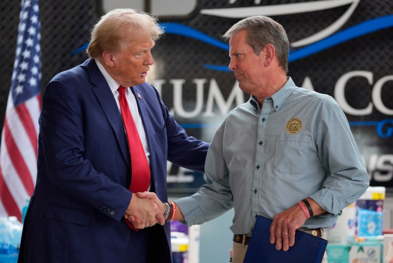 Republican presidential nominee former President Donald Trump shakes hands with Georgia Gov. Brian Kemp