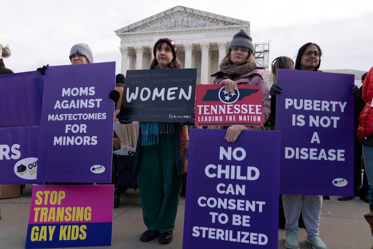 Demonstrators protest during a rally outside of the Supreme Court.