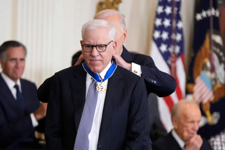 President Joe Biden, right, presents the Presidential Medal of Freedom, the Nation's highest civilian honor, to David Rubenstein in the East Room of the White House, Saturday, Jan. 4, 2025, in Washington.