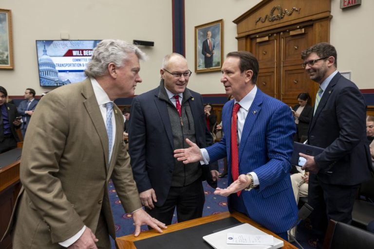 Rep. Mike Collins (R-GA) and Rep. Pete Stauber (R-MN) talk with Gov. Jeff Landry (R-LA) before the start of a hearing of the House Committee on Transportation and Infrastructure.