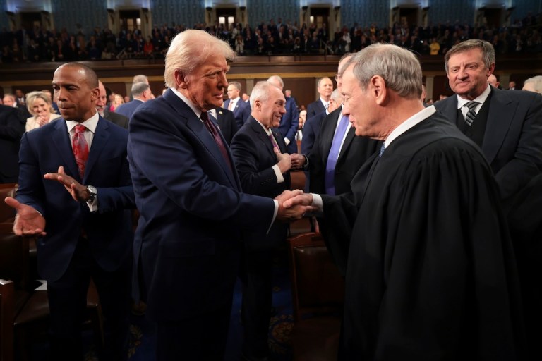 President Donald Trump, center, greets Chief Justice of the Supreme Court John Roberts, right.