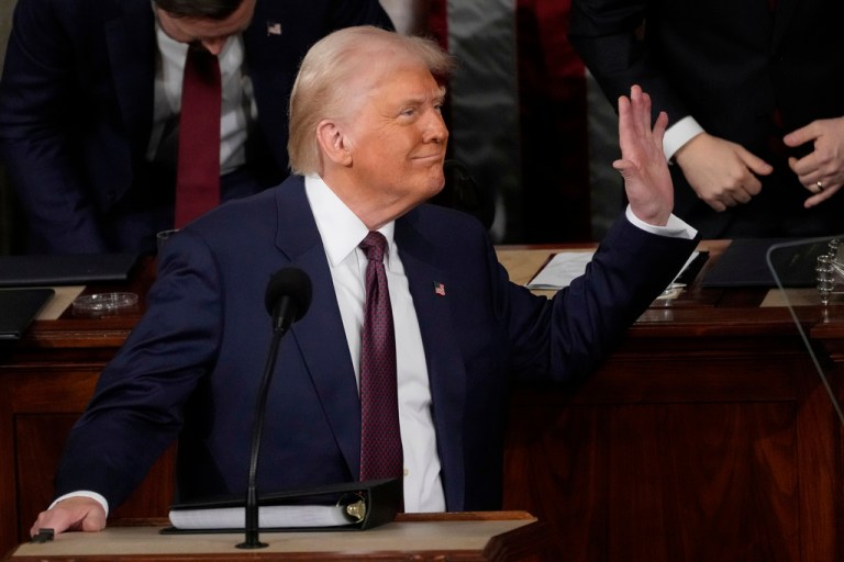 President Donald Trump waves to first lady Melania Trump as he addresses a joint session of Congress.