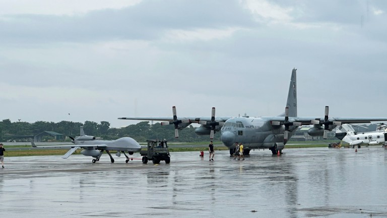A U.S. Navy drone, left, is seen beside a Philippine C130 plane at the airport of Zamboanga, southern Philippines on Tuesday June 3, 2025. (AP Photo/Joeal Calupitan)