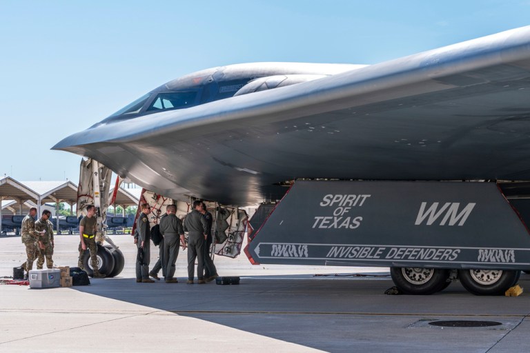 In this image provided by the U.S. Air Force, airmen assigned to the 509th Bomb Wing gather near a B-2 Spirit