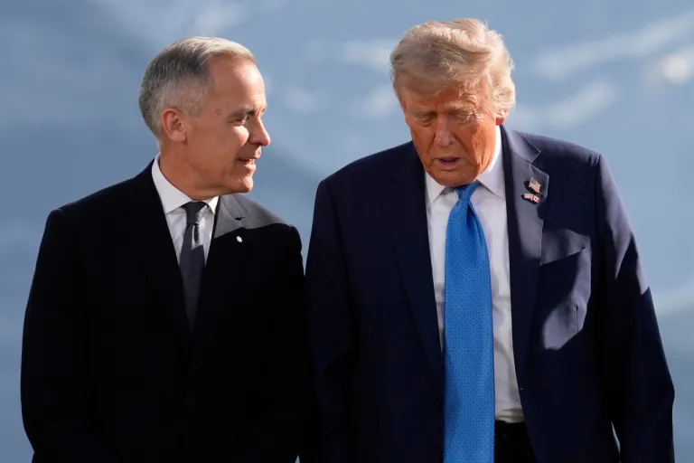 Canada's Prime Minister Mark Carney talks with President Donald Trump before a group photo at the G7