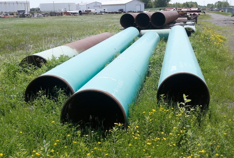 FILE - Pipeline used to carry crude oil sits at the Superior, Wis., terminal of Enbridge Energy, June 29, 2018. (AP Photo/Jim Mone, File)