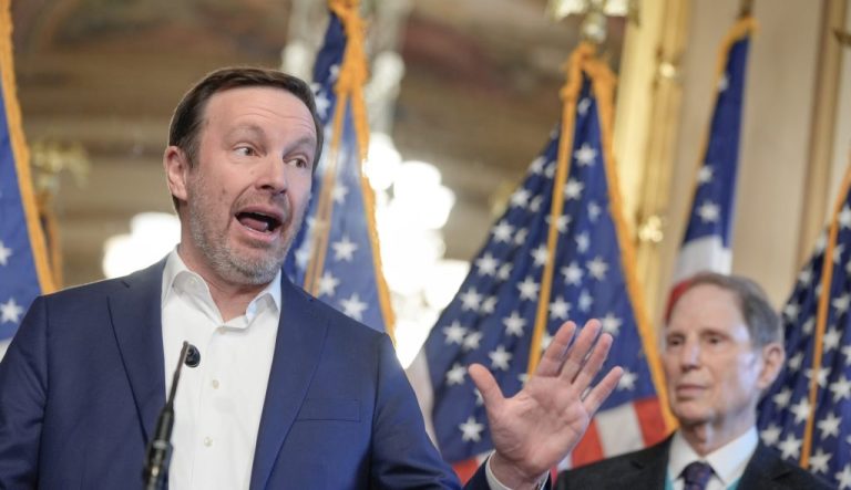 Sen. Chris Murphy (D-CT), left, speaks as Sen. Ron Wyden (D-OR), right, listens.
