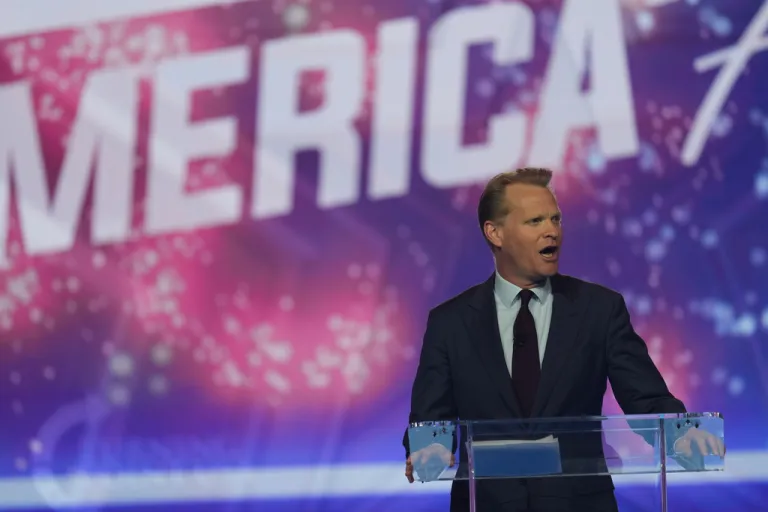 James Orr speaks on stage at AmericaFest