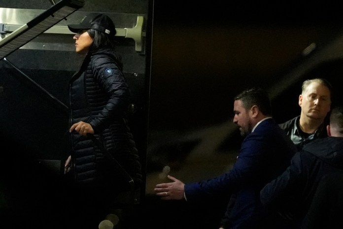 Director of National Intelligence Tulsi Gabbard, left, and FBI Deputy Director Andrew Bailey, enter a command vehicle