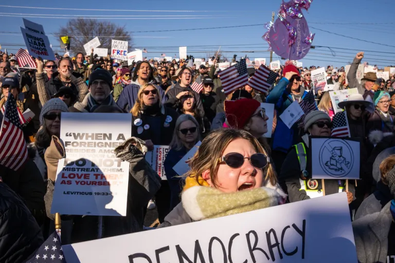 The crowd cheers for speakers during a 