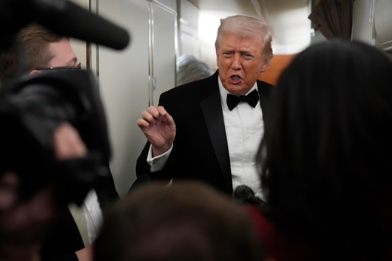 President Donald Trump speaks with reporters aboard Air Force One as he travels from Joint Base Andrews, Md. to West Palm Beach, Fla., Saturday, Jan. 31, 2026. (AP Photo/Mark Schiefelbein)
