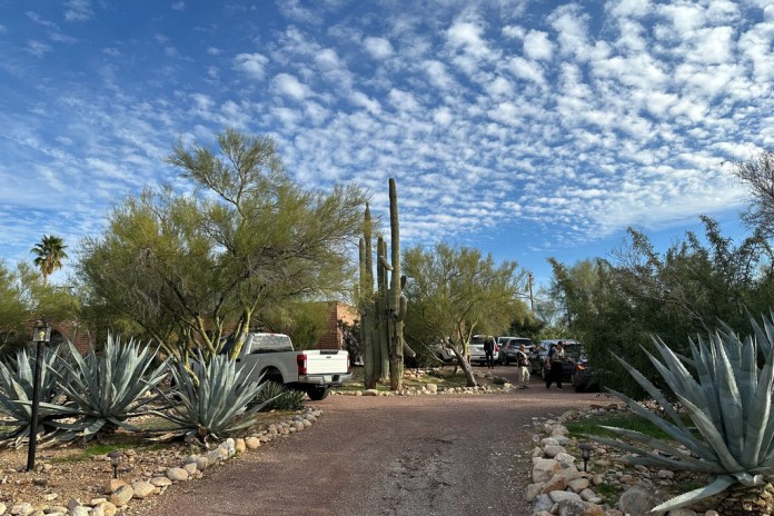 Law enforcement officers are present outside the home of Nancy Guthrie, the mother of "Today" host Savannah Guthrie, near Tucson, Ariz., Monday, Feb. 2, 2026. 
