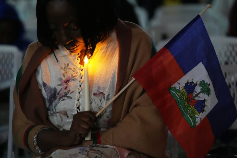 Linda Joseph holds a candle during a vigil at the Little Haiti Cultural Complex after a federal judge blocked the Trump administration from ending temporary immigration status, or TPS, for Haitians, Tuesday, Feb. 3, 2026, in North Miami. (AP Photo/Lynne Sladky)