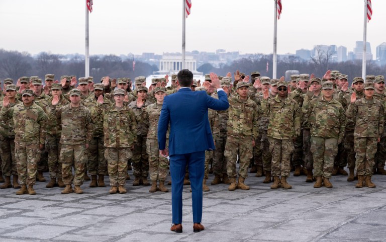 Defense Secretary Pete Hegseth administers the oath of enlistment to a group of National Guard soldiers, at the base of the Washington Monument, Friday, Feb. 6, 2026 in Washington. (AP Photo/Kevin Wolf)