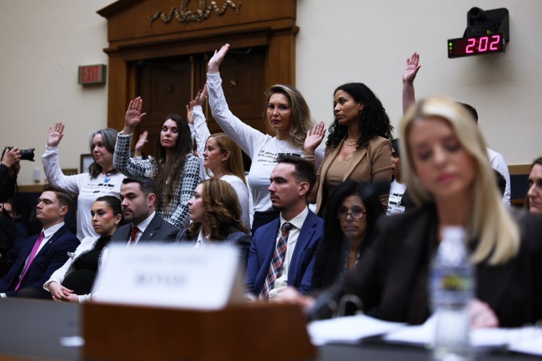 Attorney General Pam Bondi refuses to acknowledge the survivors raising their hands behind her as she testifies before a House Judiciary Committee oversight hearing on Capitol Hill in Washington, Feb. 11, 2026, in front of survivors of convicted sex offender Jeffrey Epstein. (AP Photo/Tom Brenner, File)