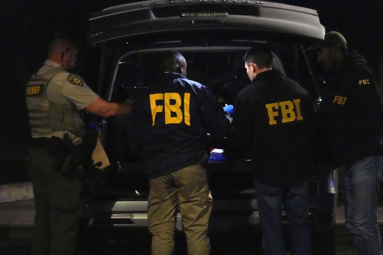 Pima County sheriff and FBI work on a Range Rover in a Culver’s parking lot in Tucson, Ariz. early Saturday, Feb. 14, 2026. (AP Photo/Ty ONeil)