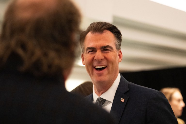Oklahoma Gov. Kevin Stitt speaks with an individual following an event at the National Governors Association Winter Meeting, Thursday, Feb. 19, 2026, in Washington. (AP Photo/Allison Robbert)