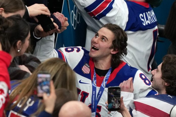 Jack Hughes (86), who scored the winning overtime goal, celebrates after defeating Canada.