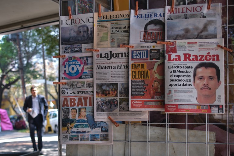 Newspapers hang on display for sale in Mexico City, Monday, Feb. 23, 2026, a day after the Mexican army killed Jalisco New Generation Cartel leader Nemesio Oseguera Cervantes, known as 