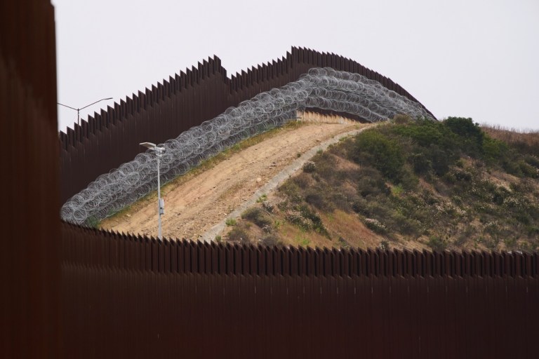 Concertina wire lines the interior of a border wall separating Tijuana, Mexico, from the United States, June 4, 2025, in San Diego.