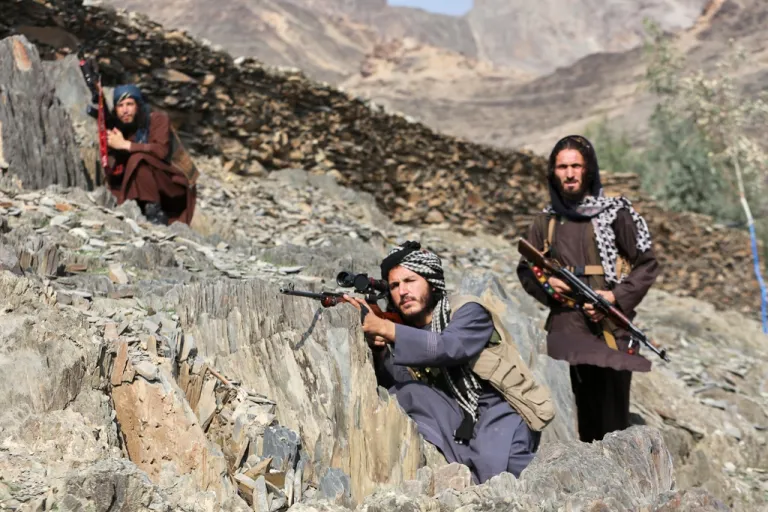 Afghan Taliban soldiers look toward the Pakistani side,