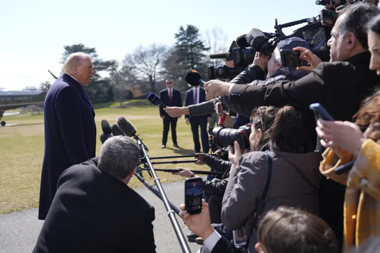President Donald Trump speaks to the media as he departs the White House.