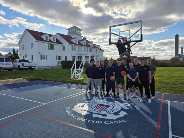 Service members at U.S. Coast Guard Station Cape Cod Canal take a photo on their new sports court, which was built through Operation Restore Habitability (Credit: USCG)