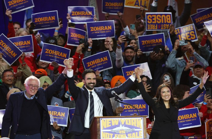 Rep. Alexandria Ocasio-Cortez (D-NY) and Sen. Bernie Sanders (I-VT) helped a fellow socialist, New York City Mayor Zohran Mamdani, win both the Democratic primary and the general election. (Heather Khalifa/AP)