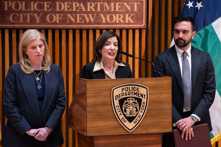 Jessica Tisch, commissioner of the New York Police Department (NYPD), from left, Kathy Hochul, governor of New York, and Zohran Mamdani, mayor of New York, during a public safety announcement at 1 Police Plaza in New York, US, on Tuesday, Jan. 6, 2026. Officials touted a record low pace for shooting incidents citywide and the lowest subway crime in sixteen years, according to a press release. Photographer: Adam Gray/Bloomberg via Getty Images
