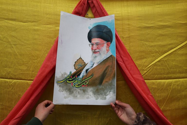 A Kashmiri Shiite Muslim boy holds a portrait of Iran's Supreme Leader, Ayatollah Ali Khamenei, during Shab-e-Barat or the night of forgiveness at a graveyard in Srinagar, Jammu and Kashmir, on February 3, 2026. Iranian Supreme Leader Ali Khamenei warns the United States that any attack on his country results in a ''regional war'' as US President Donald Trump amasses military assets in the Middle East. (Photo by Firdous Nazir/NurPhoto via Getty Images)