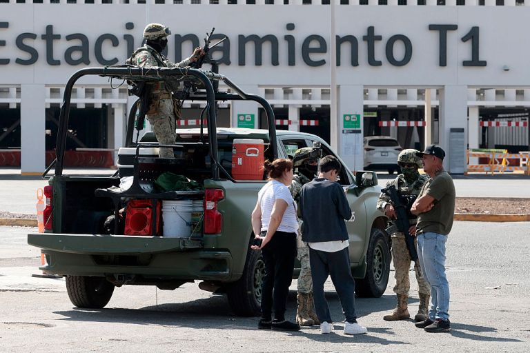 Mexican Army personnel stand guard at the parking lot of Guadalajara International Airport in Tlaquepaque, Jalisco State, Mexico, February 22, 2026. Mexico confirmed on February 22 that soldiers killed a powerful drug cartel leader who was one of the most wanted men here and in the United States. Nemesio Oseguera, the 59-year-old leader of the violent Jalisco New Generation Cartel, was wounded in a clash with soldiers in the town of Tapalpa and died while being flown to Mexico City, the army said in a statement. (Photo by Ulises Ruiz / AFP via Getty Images)