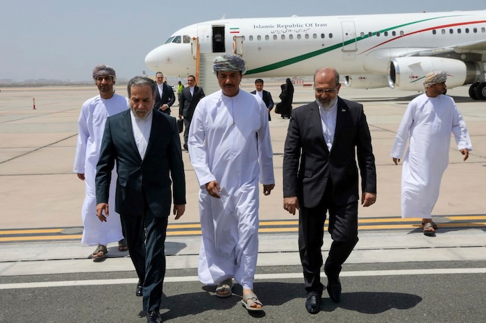 In this photo released by the Iranian Foreign Ministry, Iranian Foreign Minister Abbas Araghchi, left, is welcomed by an unidentified Omani official, center, upon his arrival at Muscat, Oman, for negotiations with U.S. Mideast envoy Steve Witkoff, as Iranian Ambassador to Oman Mousa Farhang walks at right, May 11, 2025. (Iranian Foreign Ministry via AP, File)
