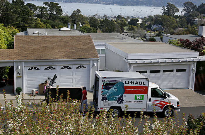In this 2020 photo, a sofa is carried to a U-Haul rental moving truck as people move out of their home in Sausalito, California. (Eric Risberg/AP)