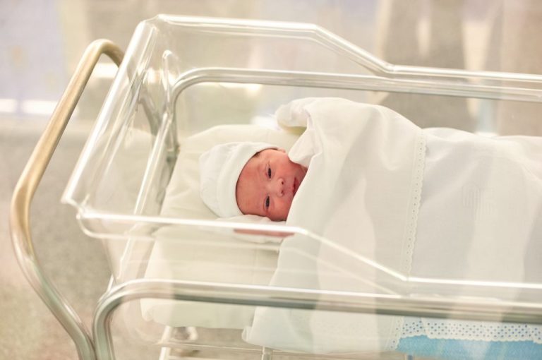 Newborn baby in a hospital recovery room family children birth rate birthrate