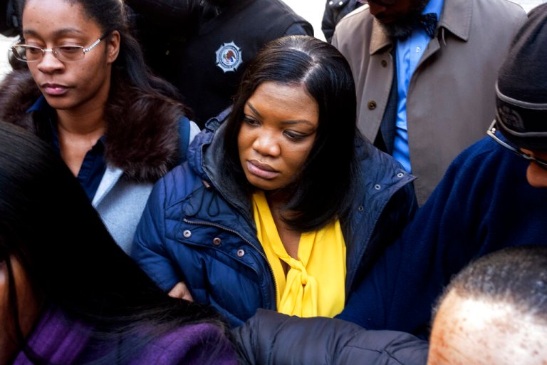 FILE — In this Nov. 25, 2019 file photo, Tova Noel, center in yellow blouse, a federal jail guard responsible for monitoring Jeffrey Epstein the night he killed himself, leaves federal court, in New York. Two Bureau of Prisons guards admitted falsifying records Tuesday, May 25, 2021, after Epstein's jail death in a deferred prosecution deal that will spare them a criminal record if they fully cooperate with investigators. (AP Photo/Craig Ruttle, File)