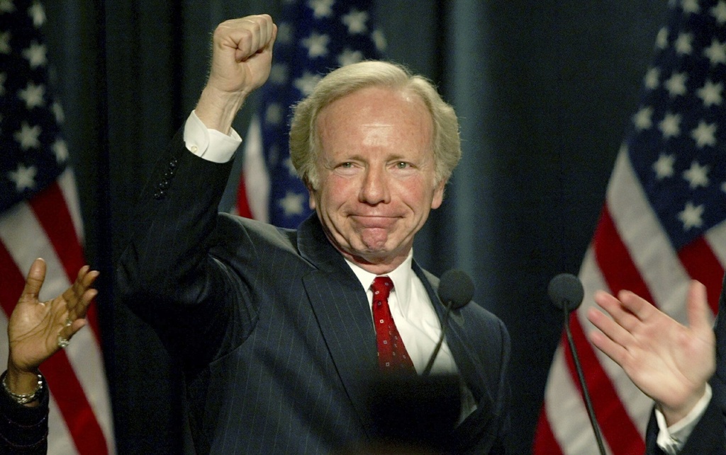 FILE - Democratic presidential hopeful Sen. Joe Lieberman, D-Conn., raises his fist after finishing his speech to the Democratic National Committee in Washington, Feb. 21. 2003. 