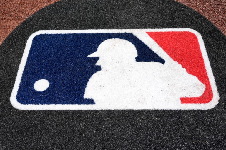 FILE - The Major League Baseball logo is seen on the field before a spring training baseball game between the Pittsburgh Pirates and the Atlanta Braves Tuesday, Feb. 27, 2024, in Bradenton, Fla. (AP Photo/Charlie Neibergall, file)