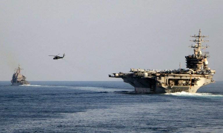 FILE - The aircraft carrier USS Dwight D. Eisenhower and other warships crosses the Strait of Hormuz into the Persian Gulf on Sunday, Nov. 26, 2023. (Information Technician Second Class Ruskin Naval/U.S. Navy via AP, file)