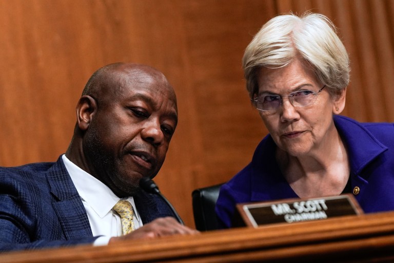 Sen. Tim Scott, R-S.C., speaks with Sen. Elizabeth Warren, D-Mass., during a Senate Committee on Banking hearing, Wednesday, June 25, 2025, on Capitol Hill in Washington.